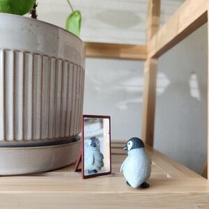 Miniature penguin figurine with mirror stand